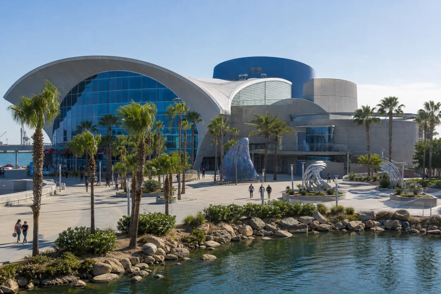Wave-inspired waterfront architecture and palm-lined plaza representing the Aquarium of the Pacific