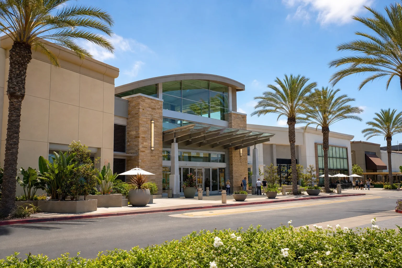 Modern shopping center entrance with palms and landscaping representing Brea Mall