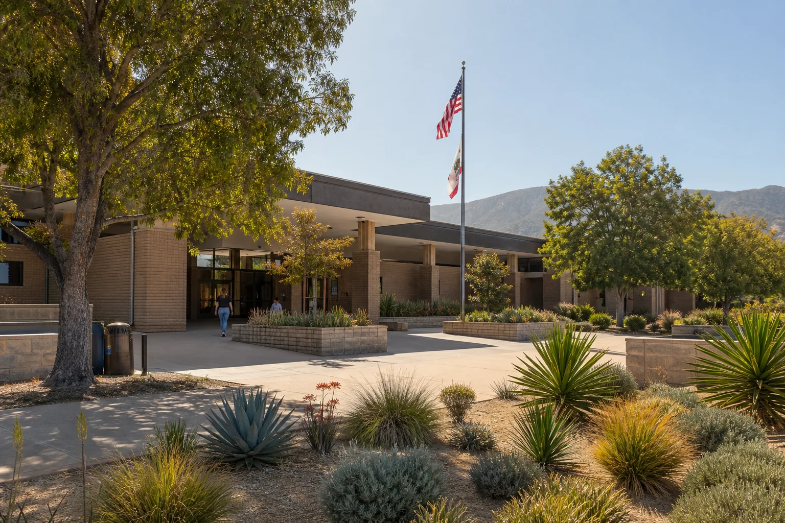 Low-rise municipal building and drought-conscious plaza representing Montclair City Hall
