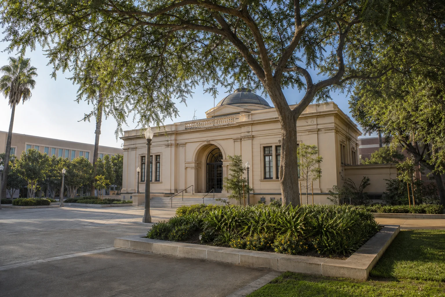 Historic civic museum building and shaded courtyard representing MUZEO in Anaheim