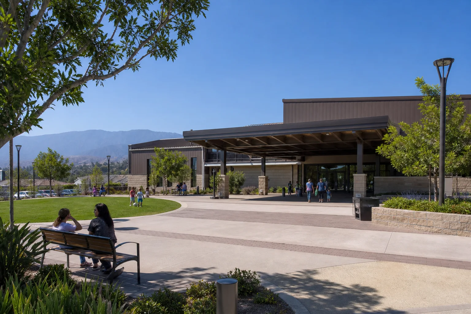 Covered community-center entrance, public plaza, and recreation lawn representing Rowland Heights Community Center