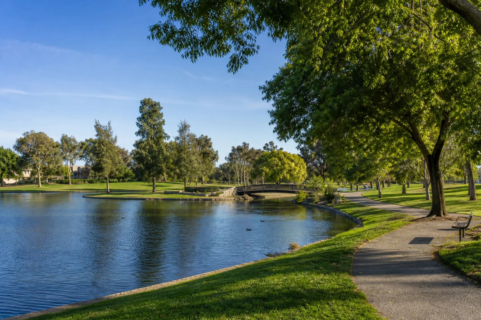 Lakeside walking path and footbridge representing Tri-City Park near Placentia