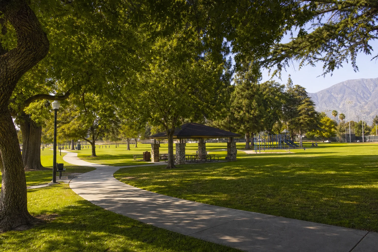 Shaded walking path and picnic pavilion representing Upland Memorial Park