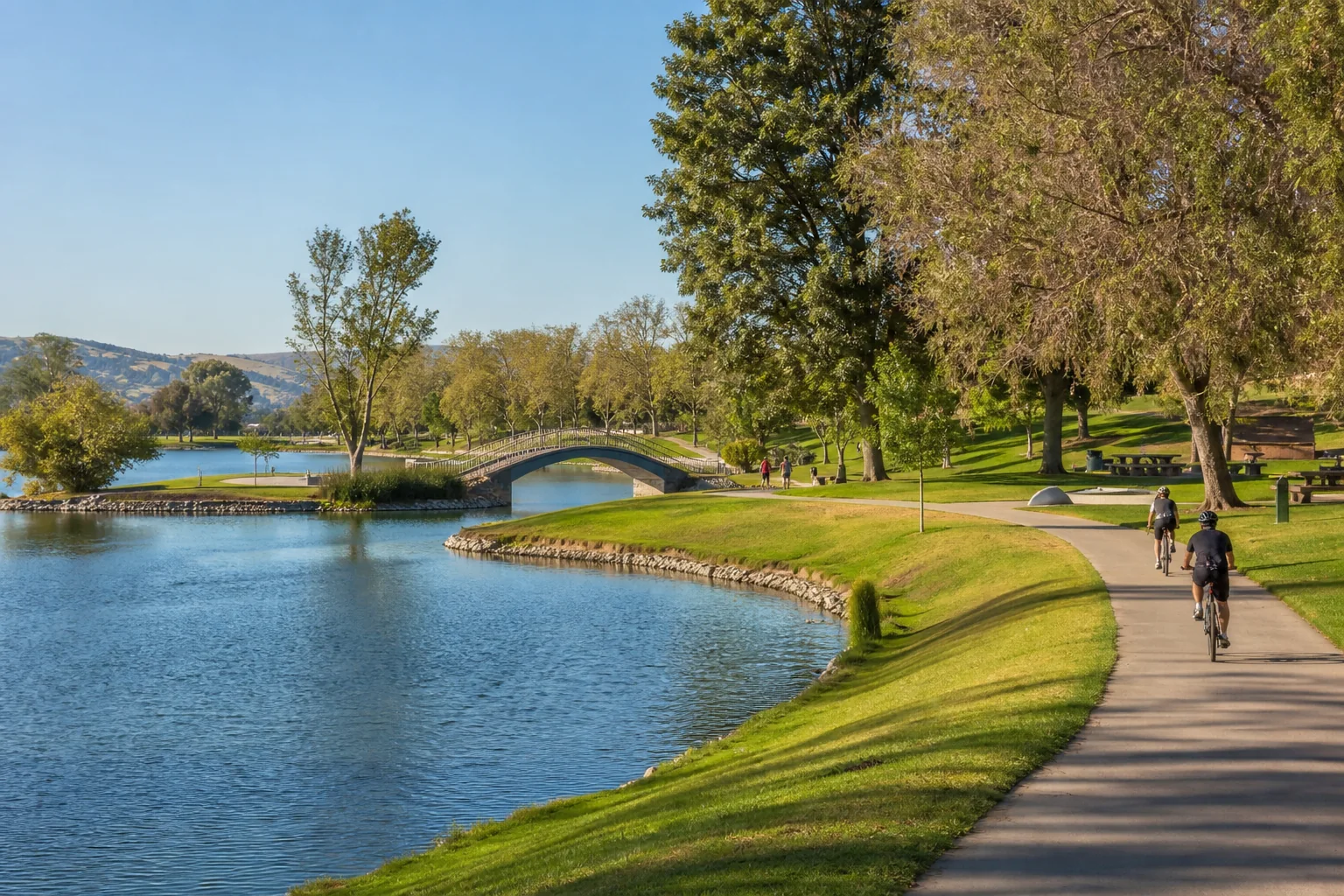 Lakeside cycling path and arched footbridge representing Yorba Regional Park