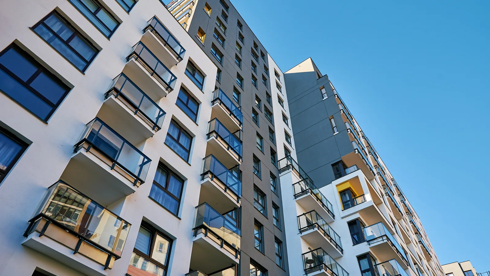 Modern multifamily residential building viewed from below