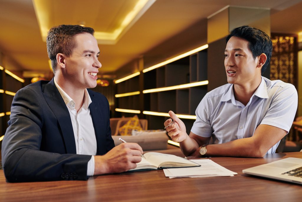 Two entrepreneurs meeting over business documents