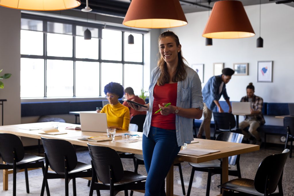 Professional using a phone in a coworking office for California LLC virtual office article