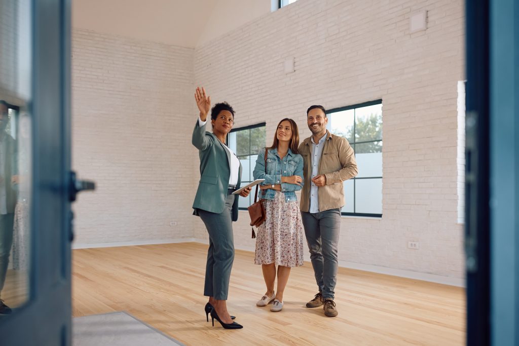 Real estate agent showing a property to clients
