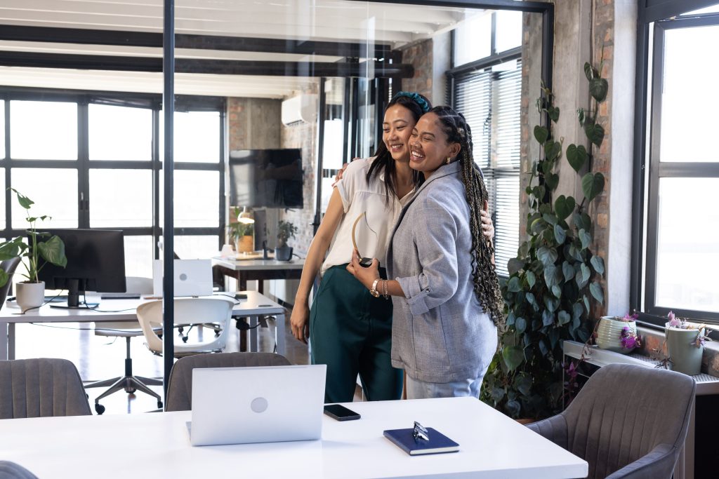 Colleagues celebrating in a modern private office