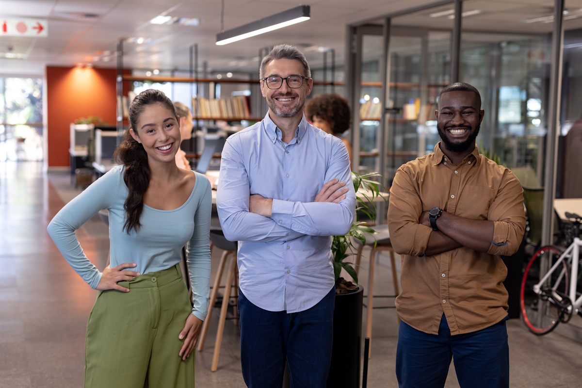 Business owners standing in a bright office while changing registered agent service