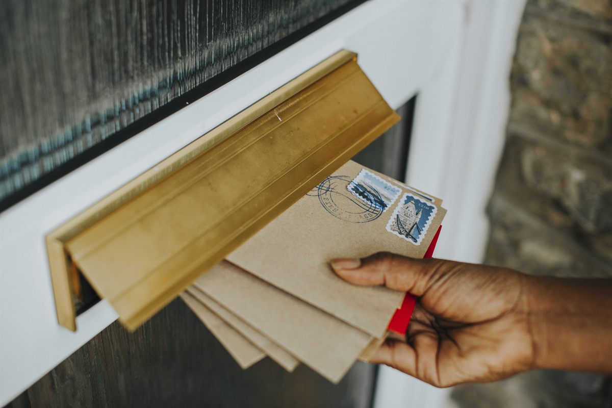 Letters being delivered through a mail slot for registered agent notices