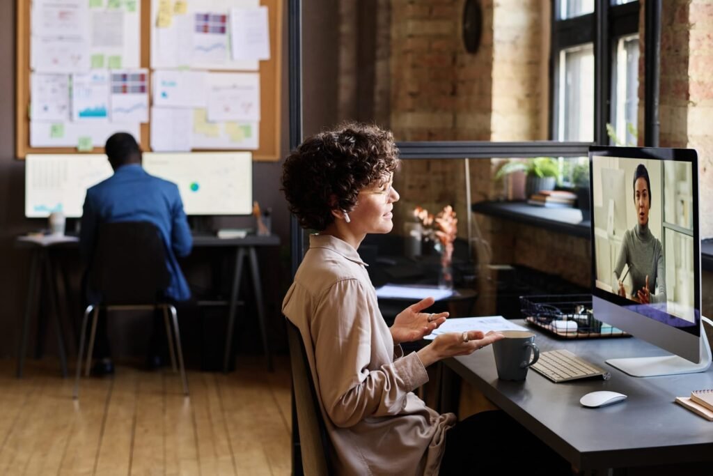 Business professional on a video conference call from an office workspace.