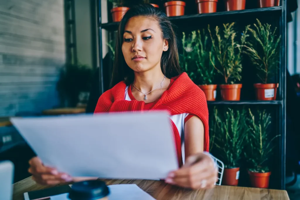 Business owner reviewing LLC documents at a desk.