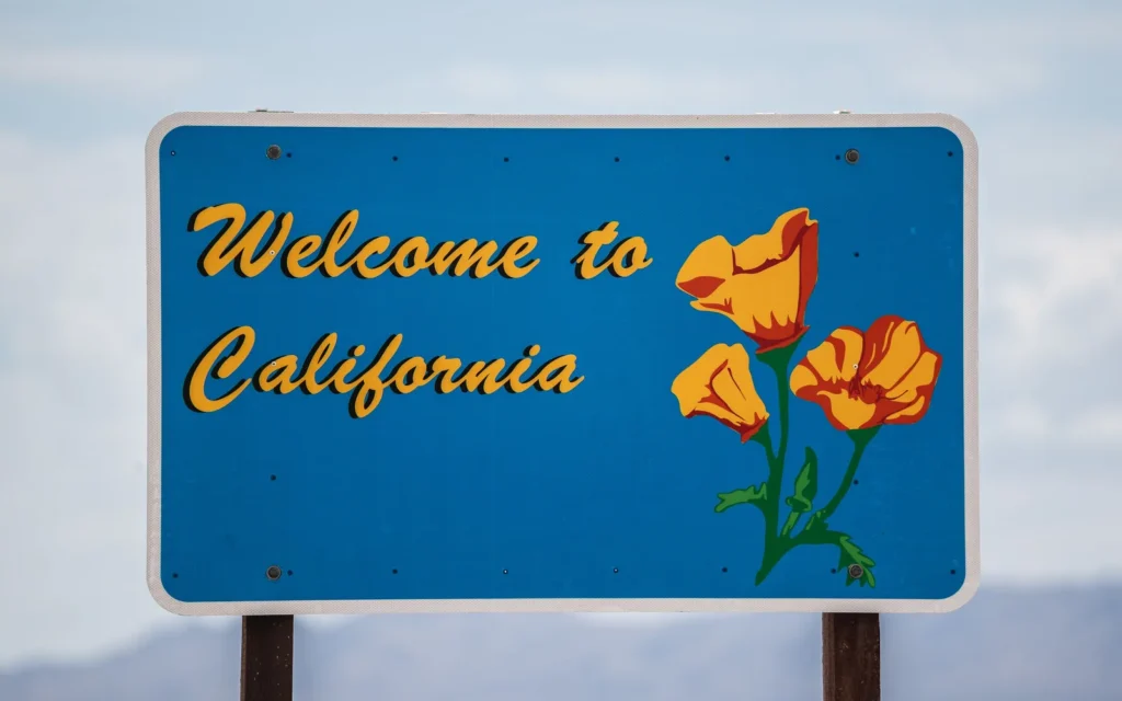 Welcome to California sign with California poppies.