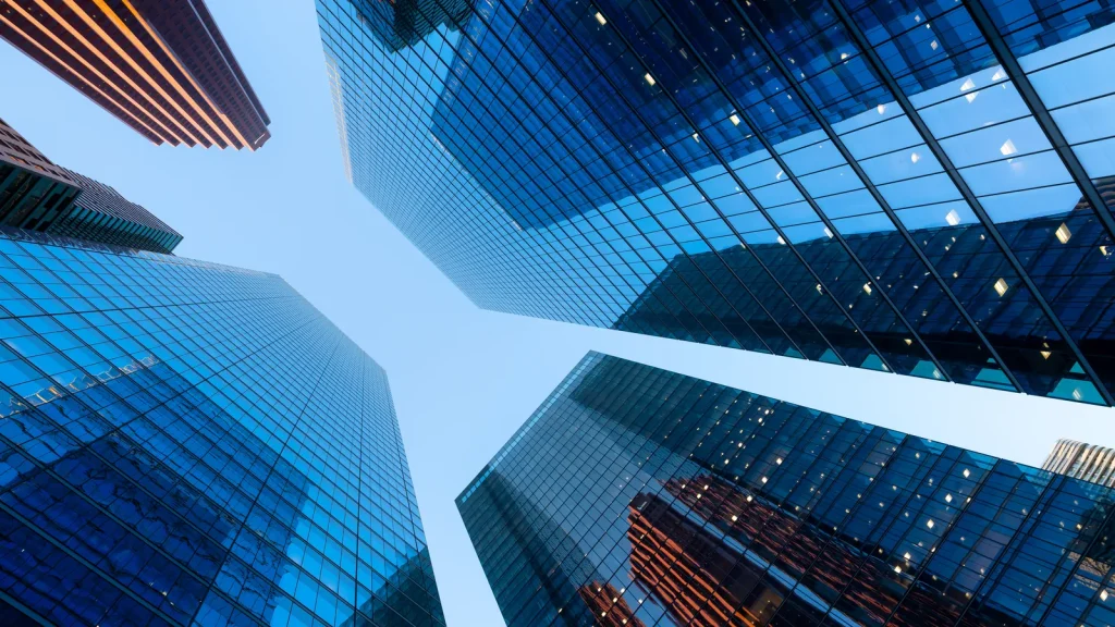 Glass office towers viewed from below in a financial district