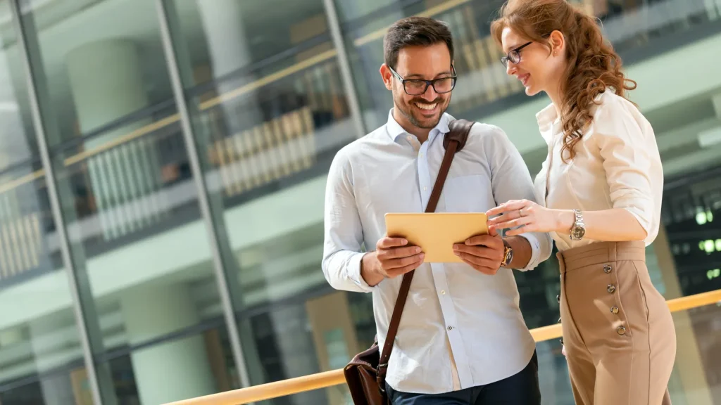 Two business colleagues reviewing information on a tablet