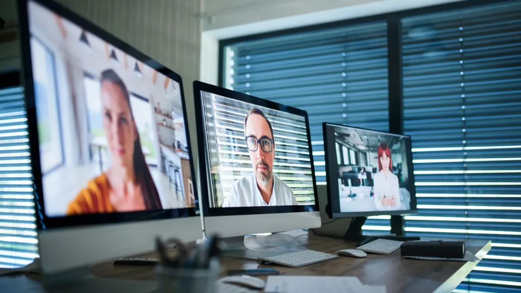 Remote business team using office computers for video meetings